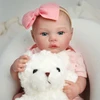 Boneca Bebê Reborn realista com macacão rosa Brastoy